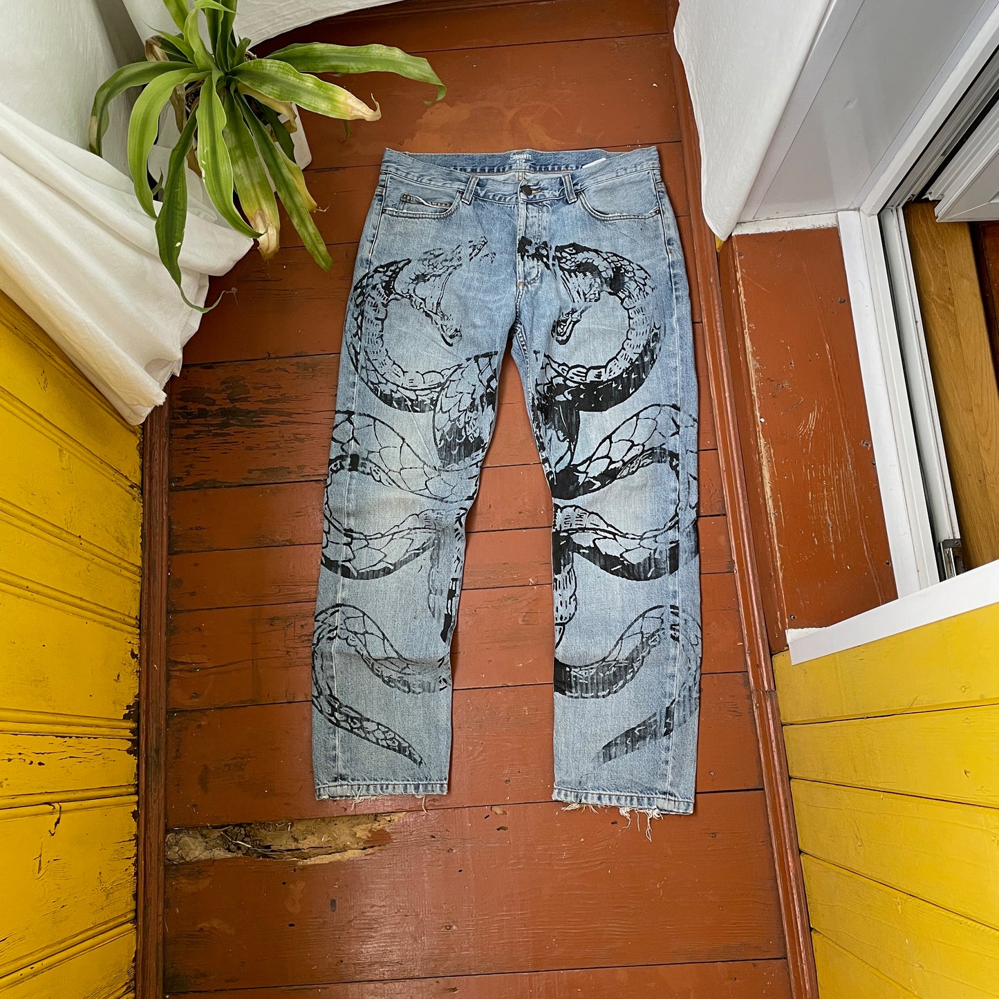 Custom Carhartt Snake Jeans โ Handprinted Black Snake Art on Faded Light Wash Denim | 1 of 1 Reworked Pants
