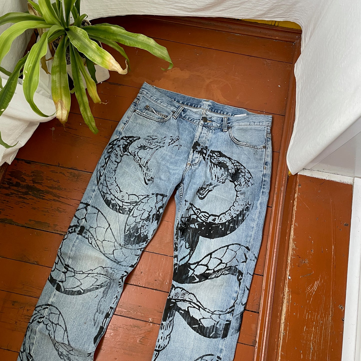 Custom Carhartt Snake Jeans โ Handprinted Black Snake Art on Faded Light Wash Denim | 1 of 1 Reworked Pants