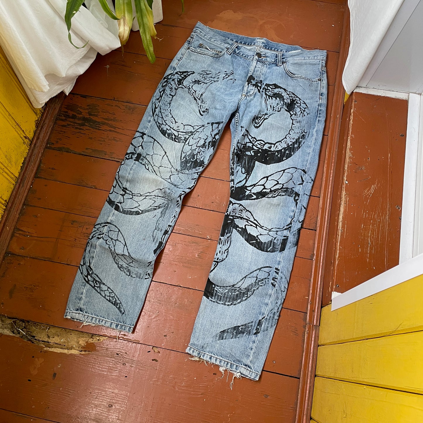 Custom Carhartt Snake Jeans โ Handprinted Black Snake Art on Faded Light Wash Denim | 1 of 1 Reworked Pants